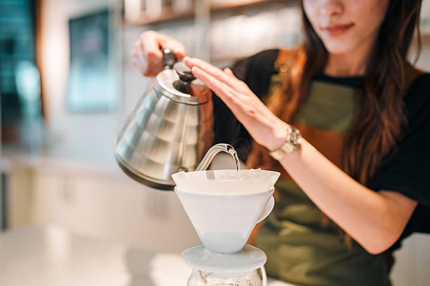 istock Female Barista Brewing Pour-Over Coffee Using V60 Dripper 2215930896
