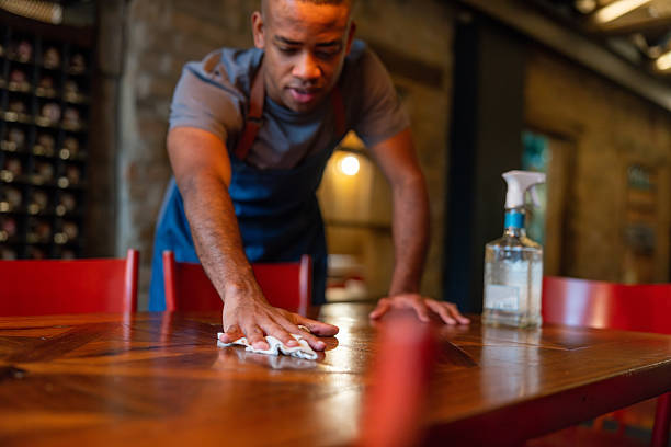 istock Waiter cleaning a table at a restaurant 2215930954
