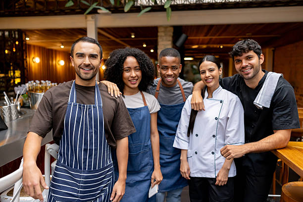 istock Happy group of employees smiling at a restaurant 2215930957