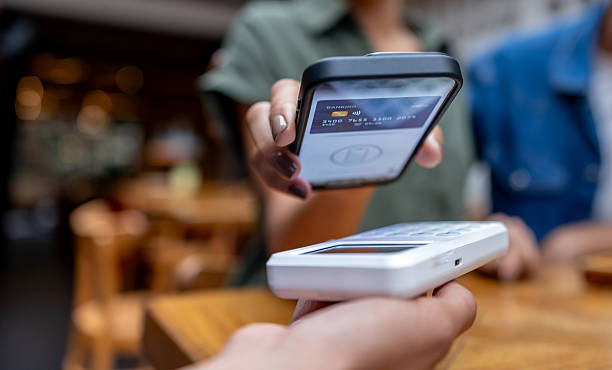 istock Close-up on a customer making a mobile payment at a restaurant 2215930977
