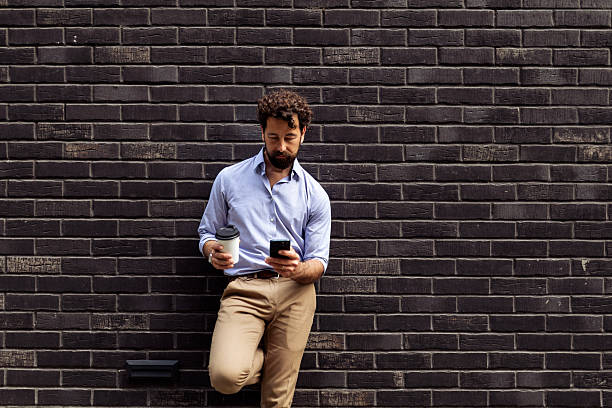 istock Modern Professional Relaxing with Coffee and Mobile Device 2215931419
