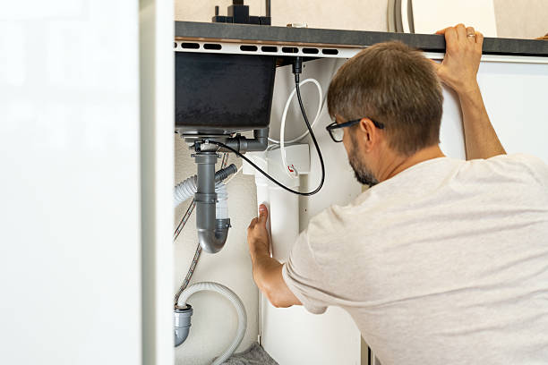 istock Plumber installs water filter. Replacement water purifier cartridges in kitchen 2215931698