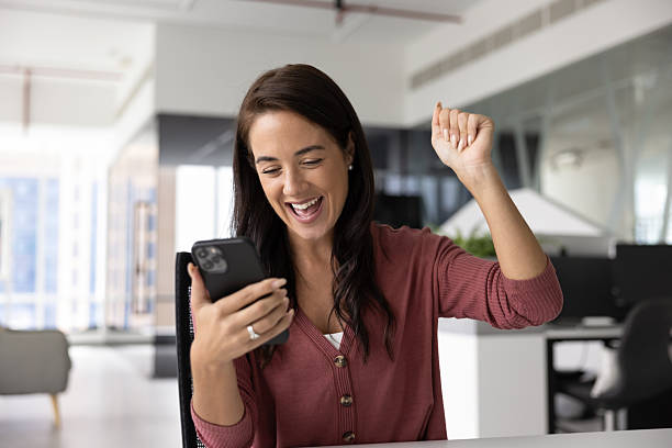 istock Excited young female make yes gesture looking on cell screen 2215933626