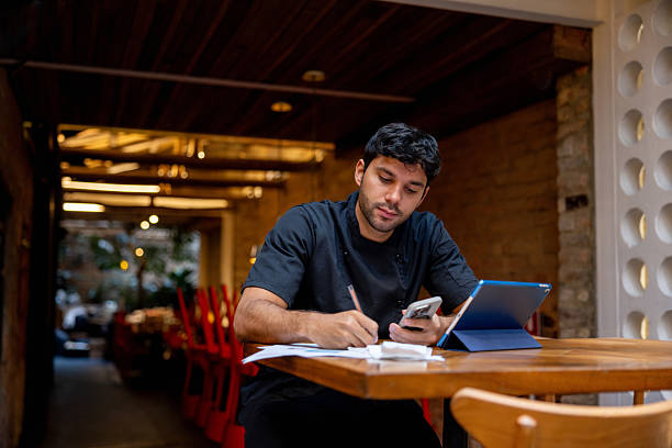 istock Chef doing the accountancy at a restaurant 2215934525