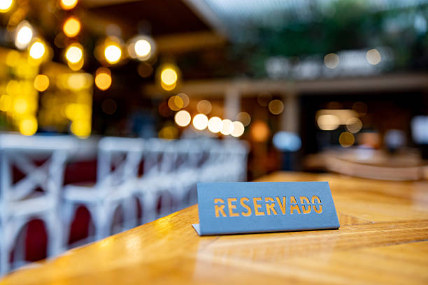 Close-up on a reserved sign in Spanish on a table at a restaurant - food service concepts