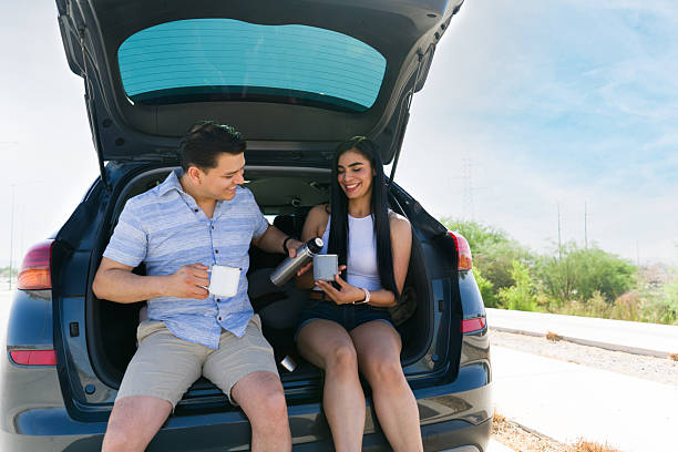 istock Happy couple enjoying coffee during road trip break 2215934582