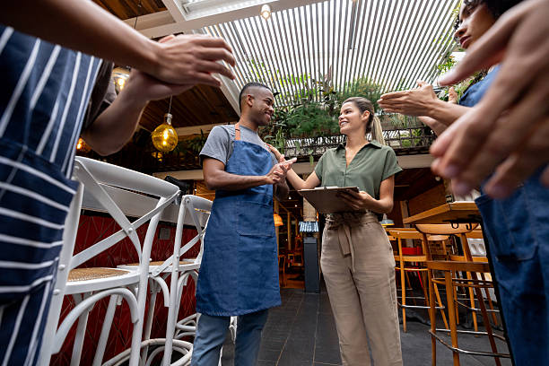 istock Happy restaurant owner introducing a new employee in a meeting 2215934588
