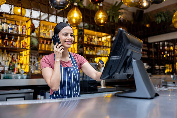 istock Happy waitress on the phone taking a reservation at a restaurant 2215934622