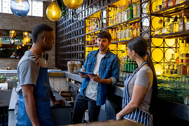 istock Restaurant manager talking to the wait staff in a meeting 2215934634