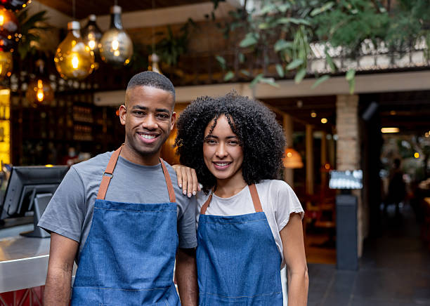 istock Food service employees smiling while working at a restaurant 2215934637