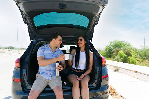 istock Latin couple enjoying coffee during road trip break 2215934645