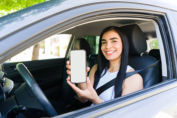 istock Female driver showing rideshare mobile app in car 2215935603