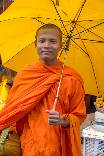 Portrait of 2 young Cambodian young monks, smiling at the camera.