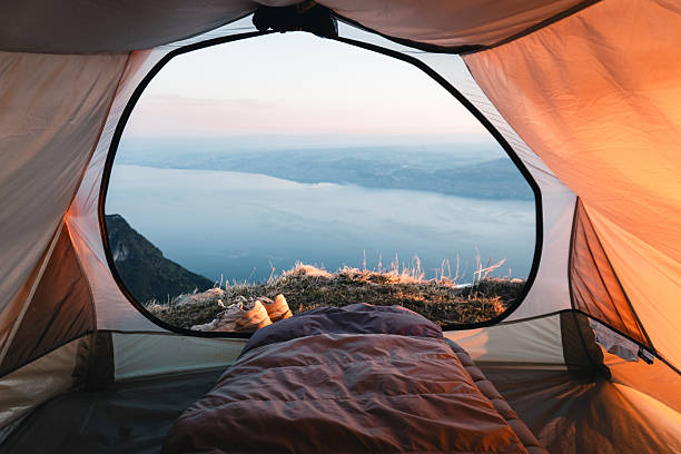 istock View past sleeping bag in tent to lake at sunrise 2215939331