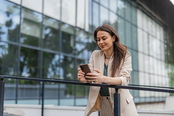 istock Confident Woman Checking Phone in Urban Setting 2215939551