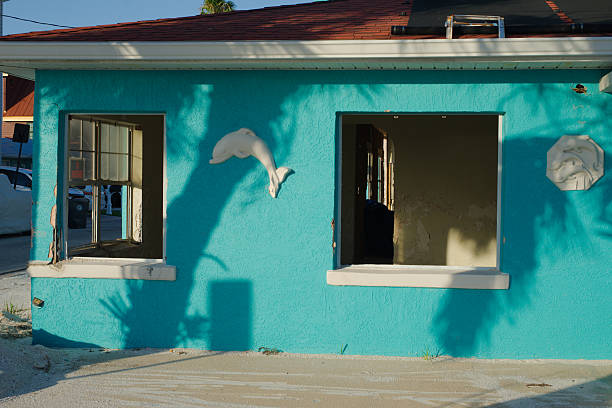 istock Brightly Painted Building with Dolphin Decorations and Open Windows 2215939651