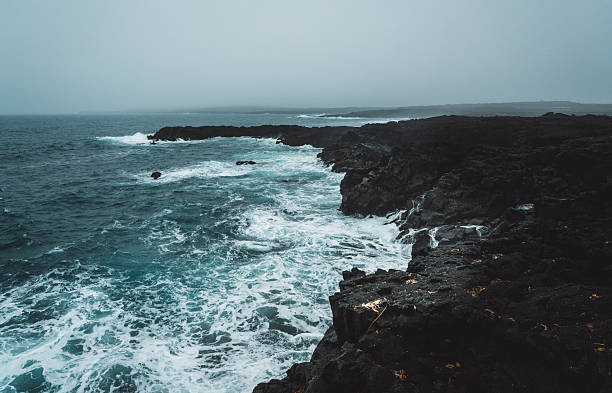 Dramatic Volcanic Coastline with Ocean Waves and Dark Basalt Cliffs in Iceland