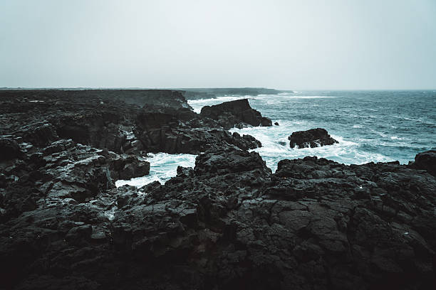 Dramatic Volcanic Coastline with Ocean Waves and Dark Basalt Cliffs in Iceland