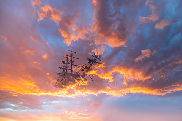 Flying old ship in the stormy clouds  at sunset