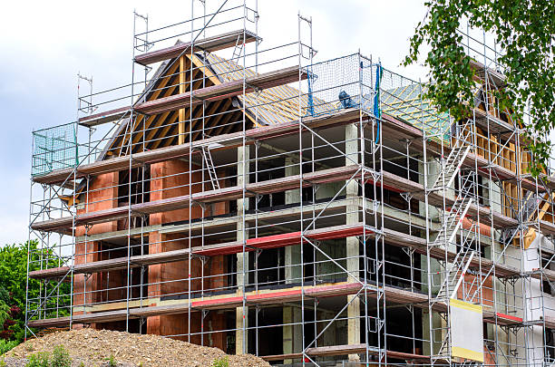 istock Construction scaffolding surrounds a house under construction in a residential area. 2215945169
