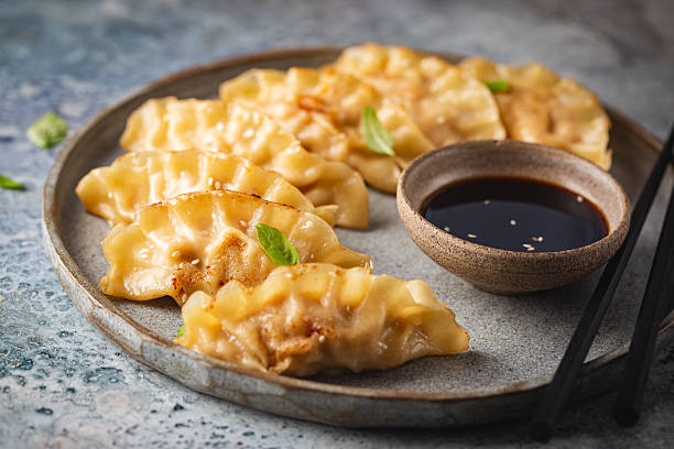 istock Asian dumplings with soy sauce 2215945178