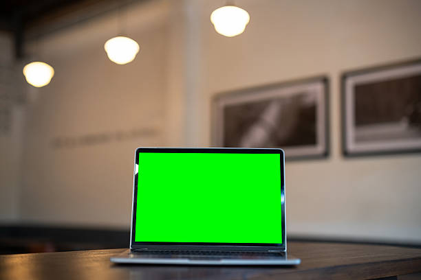 istock Mockup of laptop computer with empty screen ,ice coffee and smartphone on table side the window in the coffee shop at the cafe,Green screen 2215945206