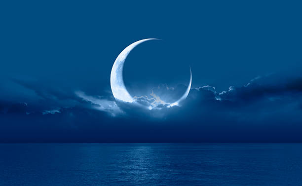 istock Ramadan concept - Crescent moon over the tropical sea at night 2215946873