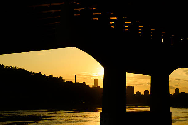 Cable bridge with bright sunset sky and reflection on water in Florianopolis, Brazil