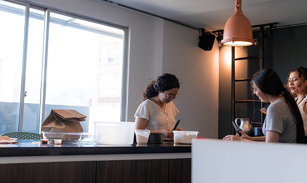 istock Friends Cooking Together in a Modern Kitchen with Natural Light and Conversation 2215947280