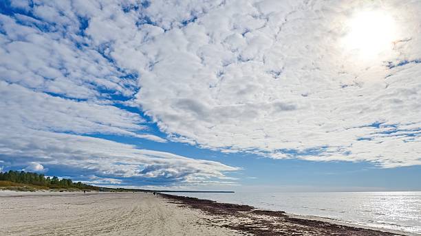 istock Cirrus clouds in a blue sky. The sun shines through the clouds. 2215947819