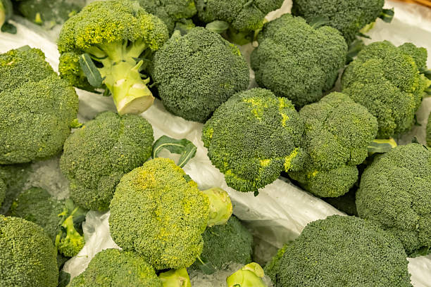 Green broccoli on vegetable counter close-up.