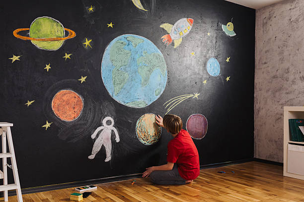 istock Boy Drawing Space Adventure on Chalkboardpr 2215953292