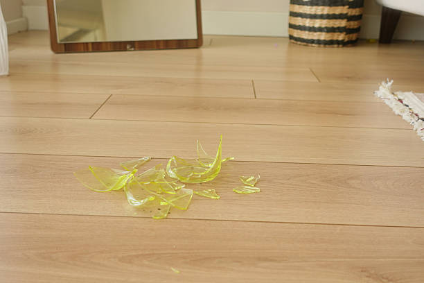 istock Broken glass scattered on wooden floor 2215954830