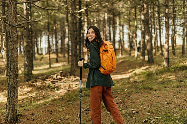 istock Young woman hiking through forest trail 2215955545