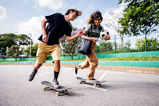 istock Friends skateboarding at the public park 2215962195