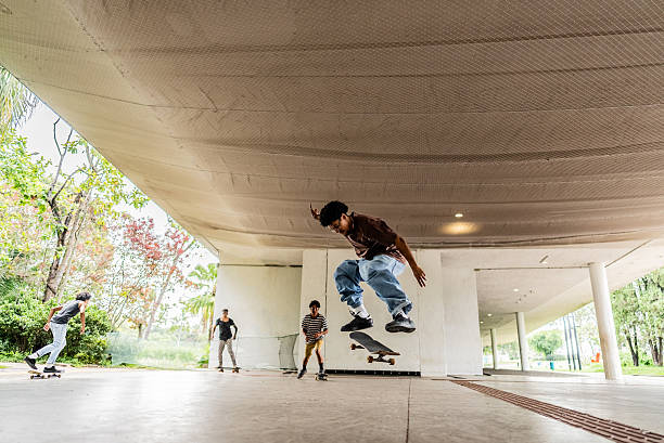 istock Young man doing skateboard trick at public park 2215962474
