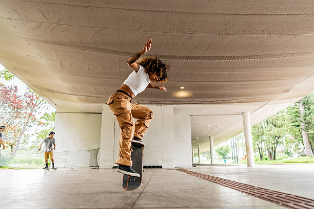 Young woman doing skateboard trick at public park