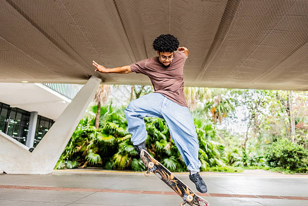 istock Young man doing skateboard trick at public park 2215962488