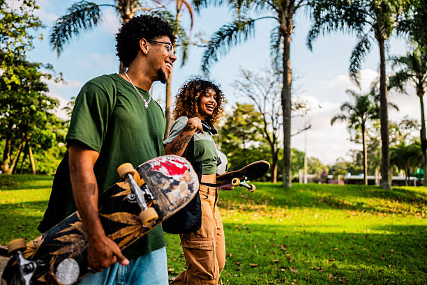istock Skater siblings talking and walking at public park 2215962577