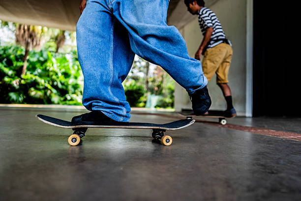 Low section of man riding a skateboard
