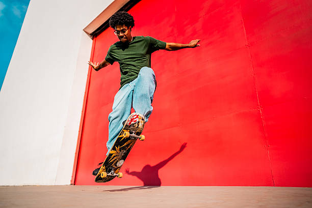 istock Young man doing skateboard trick outdoors 2215962709