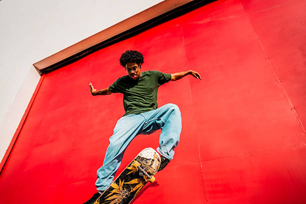 istock Young man doing skateboard trick outdoors 2215962724