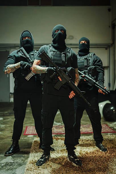 istock Intense masked operatives holding powerful rifles ready for action in a high-stakes confrontation 2215966431