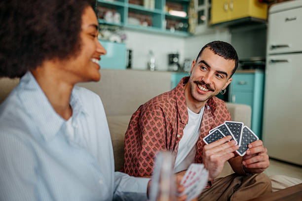 istock Couple playing cards at home 2215969318