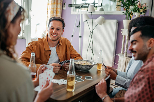 istock Friends enjoying a card game at home 2215969342