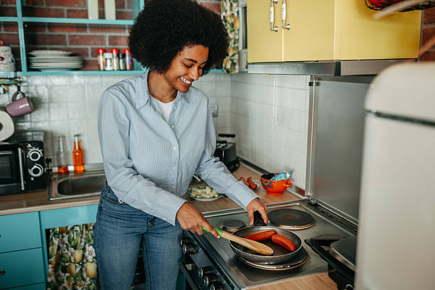 istock Smiling beautiful woman preparing breakfast at home 2215969498