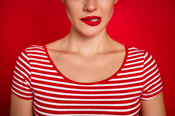 istock Cropped close up shot of young lady biting her lip oops she accidentally crashed her boyfriends car isolated on red color background 2215970594