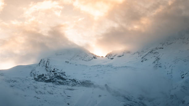 Alpenglow on snowcapped mountains, Saas Fee