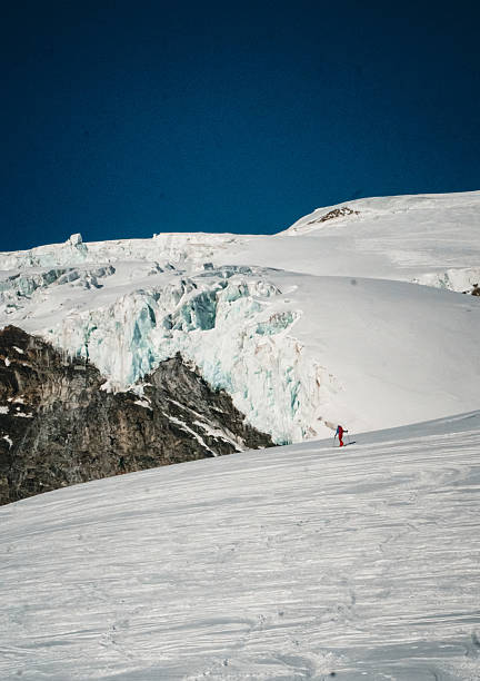 istock Ski mountaineer skis down glaciated mountain 2215971805