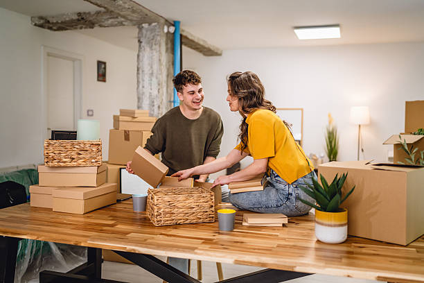 istock Happy couple having fun while unpack boxes together and drink coffee 2215971812